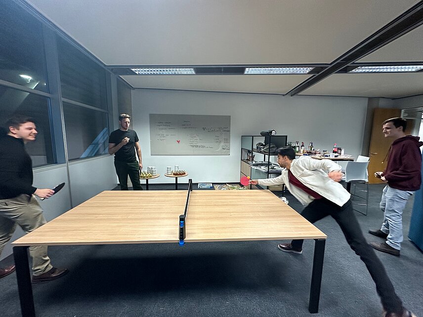 colleagues playing table tennis