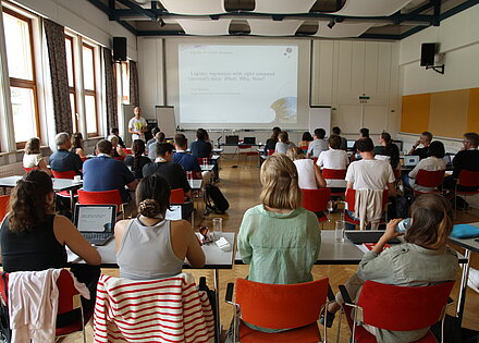 Guests listen to a talk at the summer school.